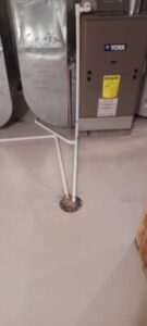 A York furnace and air handler unit with ductwork, installed or serviced by Cates Heating & Cooling in Lenexa, KS.