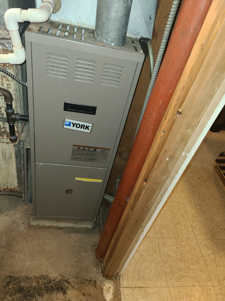 A newly installed York furnace unit in a utility room by ARC Mechanical Inc in South Elgin, IL.