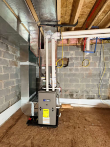 A York HVAC furnace and air handler unit with ductwork installed in a basement by Fast Air in Zebulon, NC.