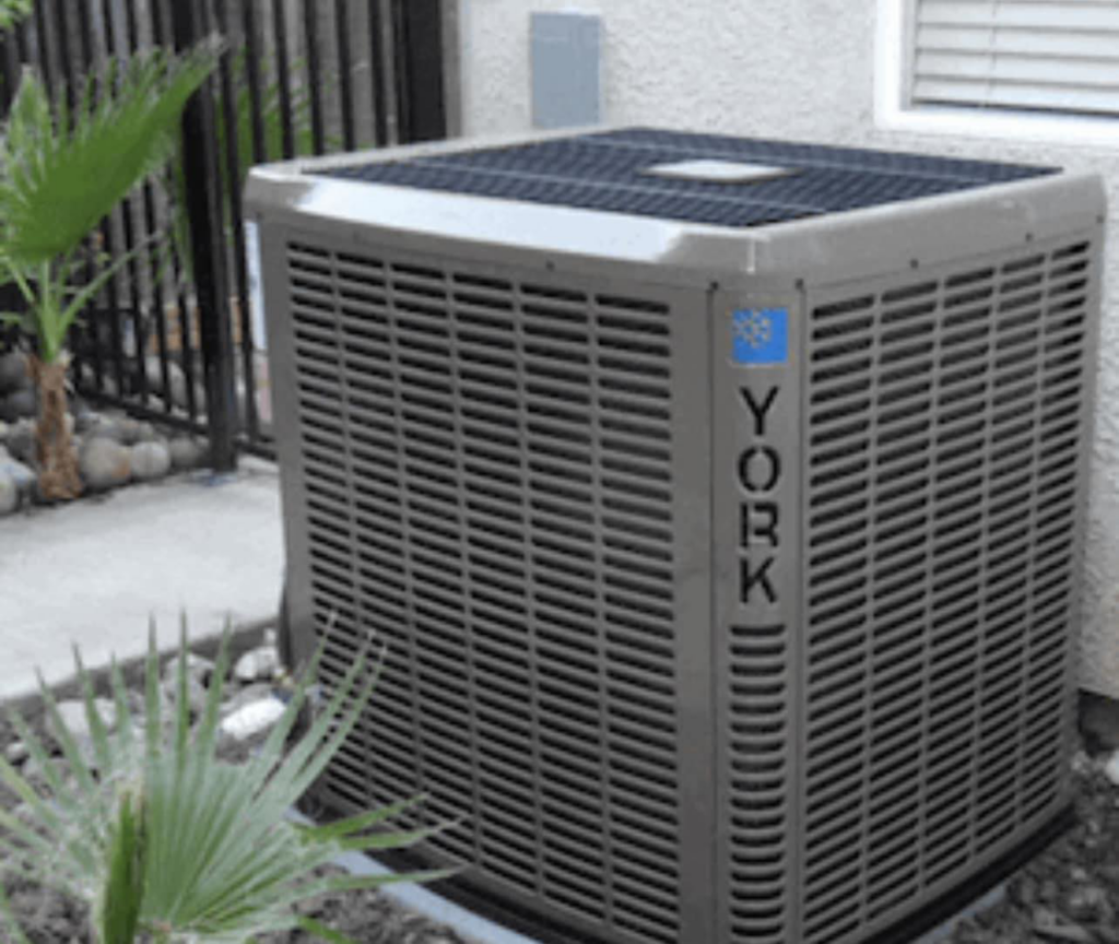 A new York HVAC outdoor unit installed next to a residential property by 1A Heating and Cooling Specialty LLc in Caldwell, ID.