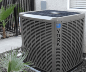 A new York HVAC outdoor unit installed next to a residential property by 1A Heating and Cooling Specialty LLc in Caldwell, ID.