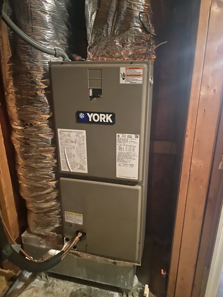 A York brand indoor furnace and air handler unit with ductwork installed by Triune Air in Smithville, TN.