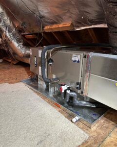 A York indoor HVAC air handler unit installed in an attic by Pappy's Heating & Air INC, serving homes in Clayton, NC.