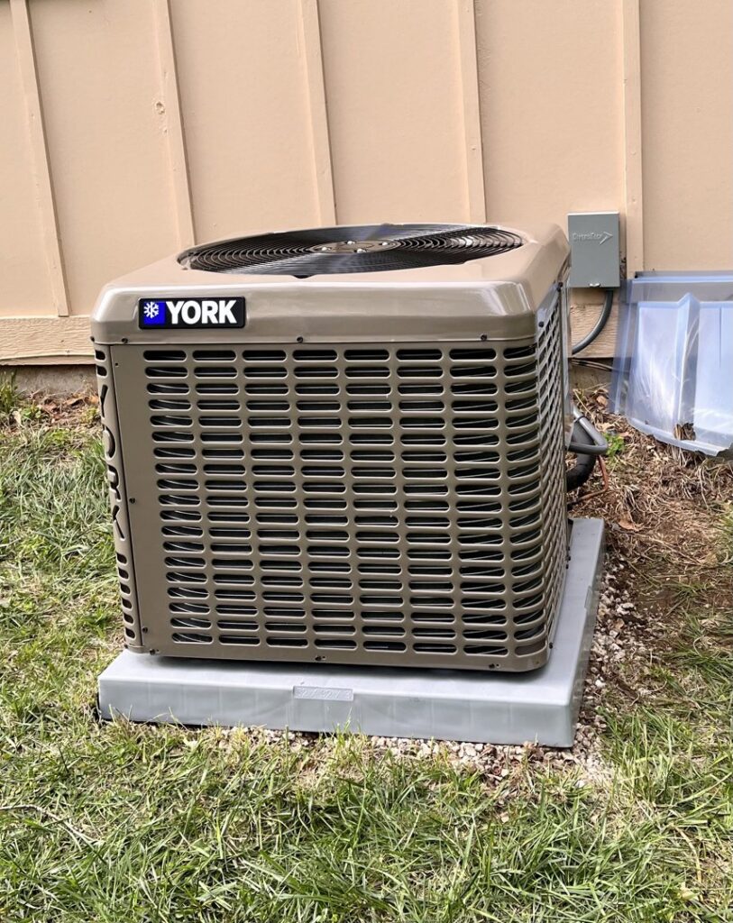 A new York outdoor AC condenser unit installed by Pronto Air, an HVAC contractor in Olathe, KS.