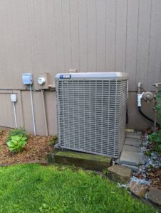 A York outdoor air conditioning unit installed next to a residential building, serviced by TAS Mechanical Services in Kearney, MO.