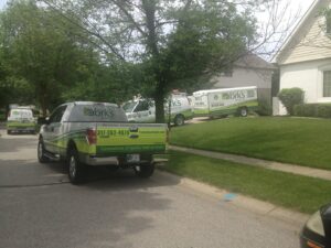 York's Quality Air service trucks and trailers parked on a residential street in Indianapolis, IN, ready for HVAC jobs.