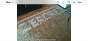 The Zerorez logo clearly cleaned into a dirty carpet, showcasing effective cleaning by Zerorez Wichita in Wichita, KS.