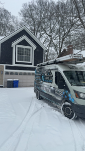 Above All Garage Doors service van parked at a residential garage door job in Kansas City, KS.