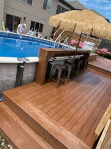 An above-ground pool integrated with a custom deck and outdoor bar, a design by Acapulco Pool and Spa LLC in Los Angeles, CA