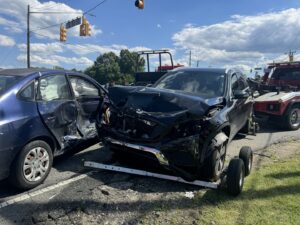 A multi-car accident scene with a J & G Towing, LLC truck on standby for recovery services in Greensboro, NC.