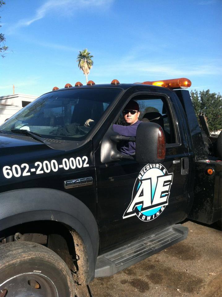 A professional tow truck driver from AE Recovery and Towing in Phoenix, AZ.