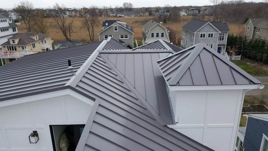 Aerial view of a house featuring crisp white horizontal siding, a project by JM Roofing & Siding in Rogers, AR.