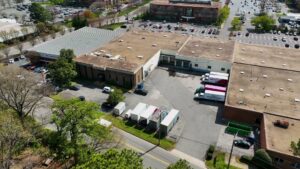An aerial view of the RCS Moving & Storage facility with multiple trucks at loading docks in Richmond, VA.
