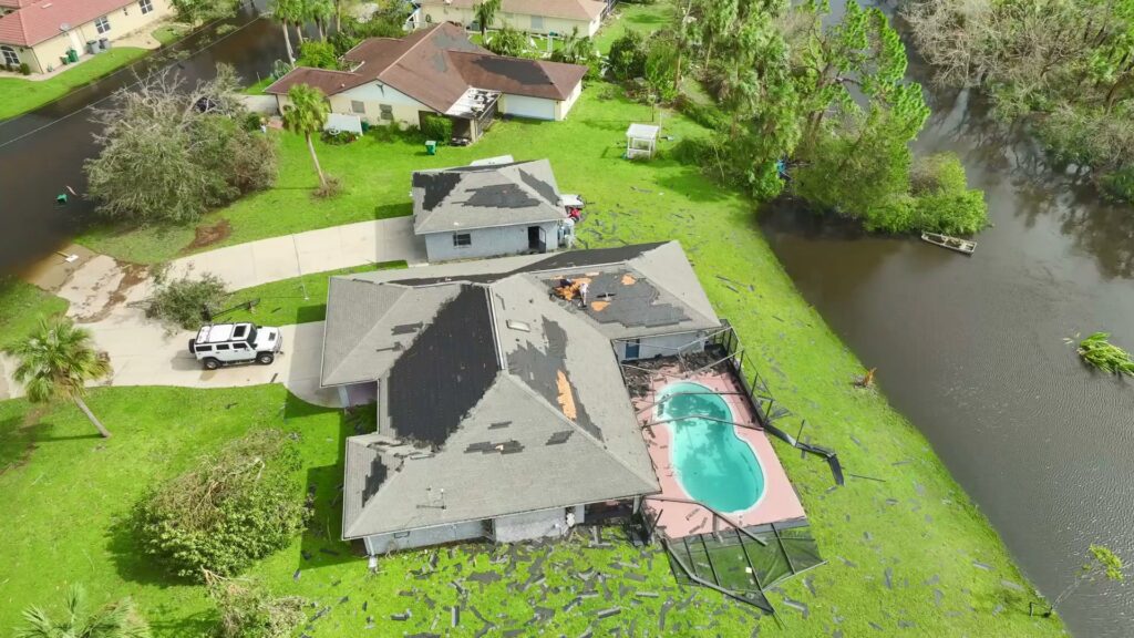An aerial view of storm-damaged homes with flooded yards, showing the aftermath of water damage in Newark, DE