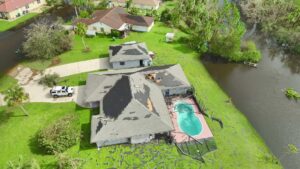 An aerial view of storm-damaged homes with flooded yards, showing the aftermath of water damage in Newark, DE