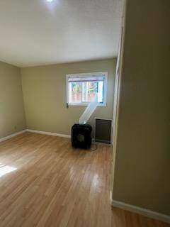 An air mover fan drying a water-damaged room with hardwood floors, part of restoration by Bordi Restoration in San Leandro, CA