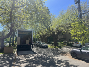 An Alto Moving truck with its ramp down and boxes ready for loading on a street in Seattle, WA.
