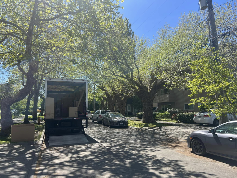 An Alto Moving truck with its ramp down and boxes ready for loading on a street in Seattle, WA.