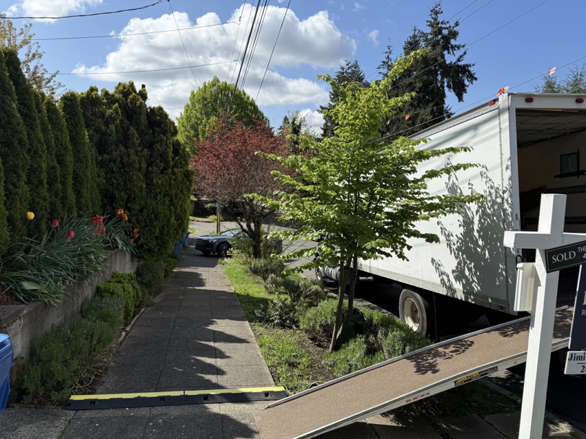 An Alto Moving truck with its ramp extended to the sidewalk for a moving job in Seattle, WA.