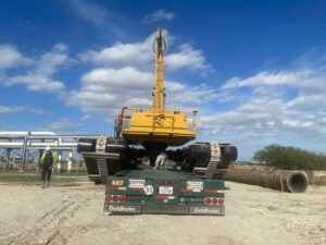 An amphibious excavator being transported on a heavy-haul trailer by CC Wrecker Service in Corpus Christi, TX.