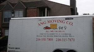 An Ang Moving Co truck parked in front of a residential building, ready for a move in Dallas, TX