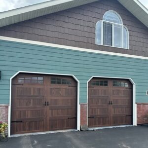 Two arched-top residential garage doors installed on a home by Riverside Garage Doors in Kalispell, MT.