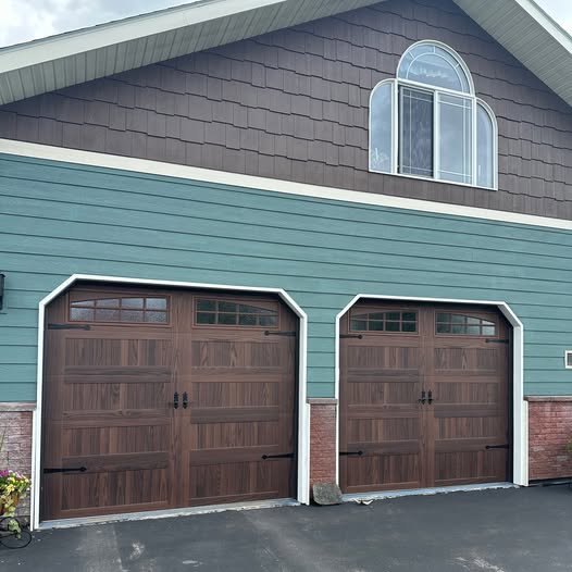 Two arched-top residential garage doors installed on a home by Riverside Garage Doors in Kalispell, MT.