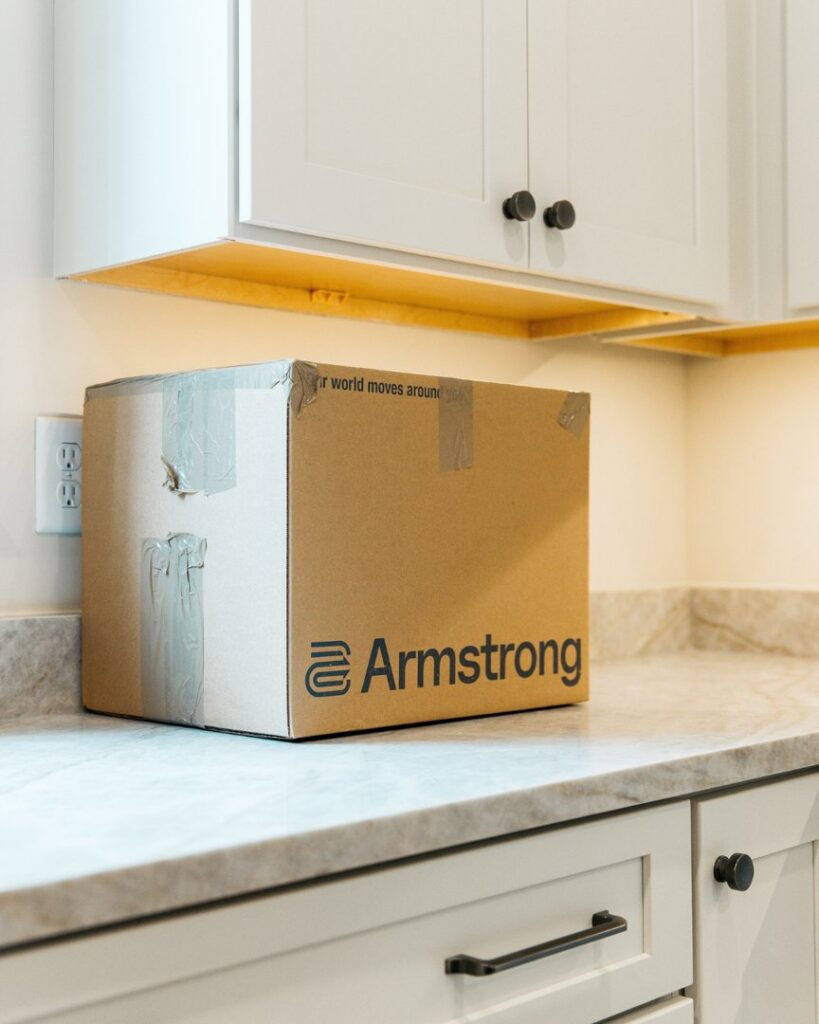 An Armstrong branded moving box sitting on a kitchen counter, ready for a move by The Armstrong Company in Huntsville, AL.
