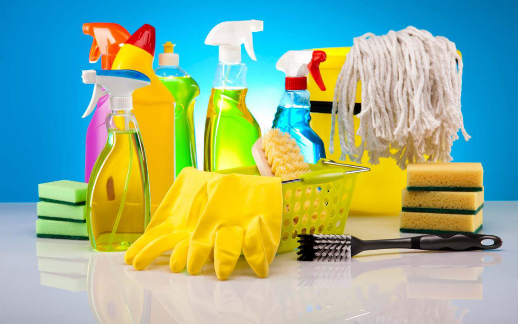 A wide assortment of cleaning products, yellow gloves, and sponges used by Roses Cleaning Services in Erie, PA.