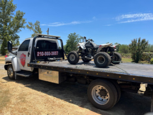 An ATV loaded onto a flatbed tow truck by AB Towing & Transport in San Antonio, TX.