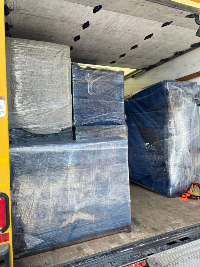 The back of a moving truck loaded with carefully wrapped furniture and boxes by Piece by Peace Moving in Colorado Springs, CO.