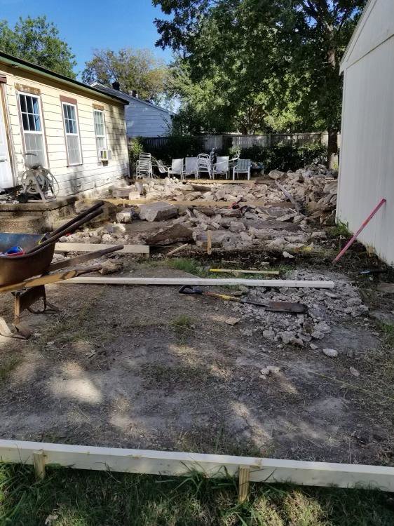 A backyard showing concrete rubble from a demolished patio or foundation by Vaquero Demolition in Lewisville, TX.