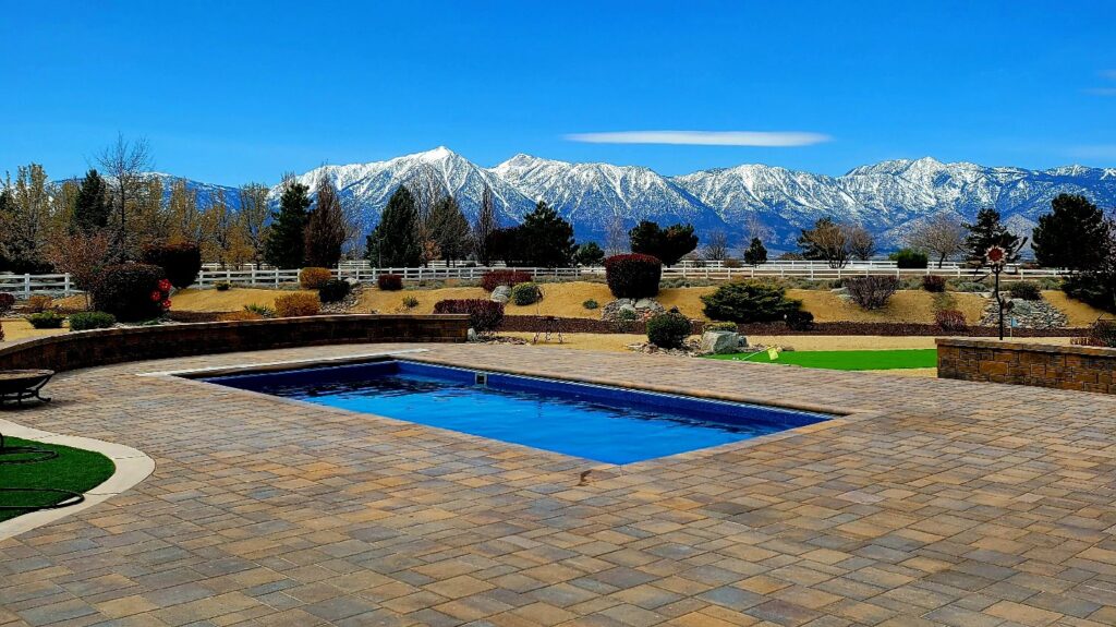 A stunning backyard featuring a newly installed in-ground pool with a scenic mountain view by Sun Leisure Pools & Spas in Sparks, NV.