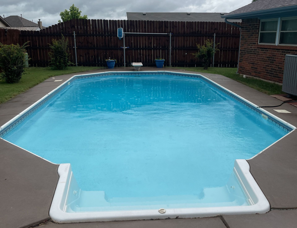 A backyard swimming pool featuring clean, inviting water and easy-access steps, maintained by AquaDocs in Dublin, OH.