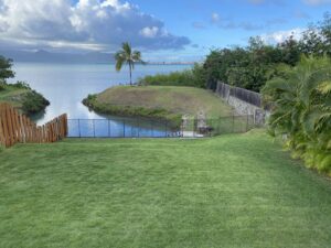 A backyard waterfront safety fence installed by Guardian Pool Fence Systems of Hawaii, securing a property near the bay in Honolulu, HI.