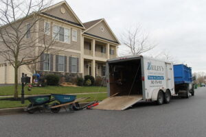 A Bailey's Lawn and Landscape crew truck and trailer parked at a residential job site, ready for lawn care in Smyrna, DE.