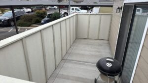 A balcony privacy wall featuring vertical siding panels, installed by Bushco Contracting LLC in Fresno, CA.