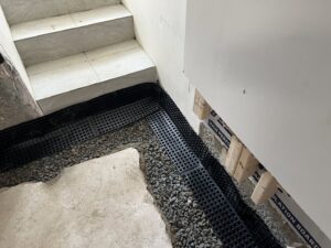Basement corner waterproofing with dimpled membrane and gravel by EFFECTIVE WATERPROOFING in Worcester, MA.