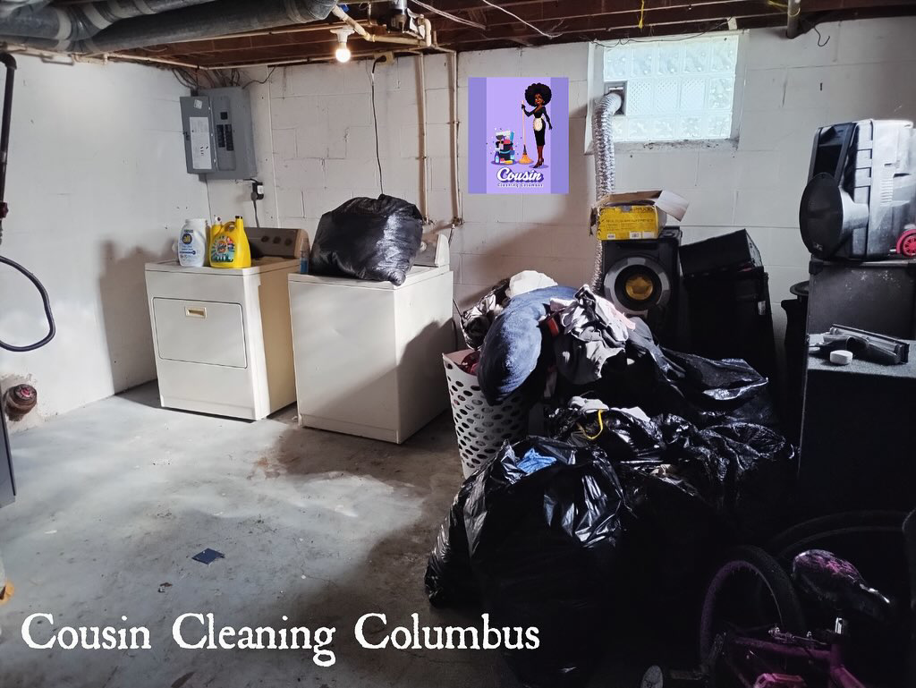A basement with a partially cleared floor and many trash bags, showing decluttering in progress by Cousin Cleaning Columbus, OH.