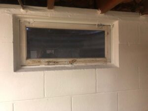 A newly installed glass block window in a basement, a common waterproofing solution provided by Northeast Wisconsin Waterproofing, LLC in Green Bay, WI.