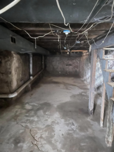 Basement gutting project with exposed pipes and concrete floor by Identical Demolition LLC in Philadelphia, PA.