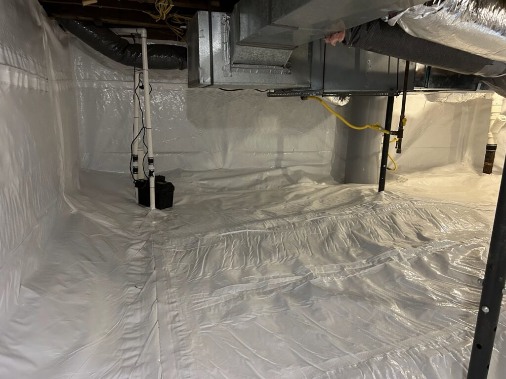 A clean, white vapor barrier installed in a basement with a sump pump by EverDry Toledo in Toledo, OH.