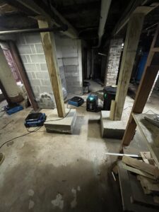 Industrial drying equipment in a basement after water damage restoration by RestoPros of New Haven in Prospect, CT