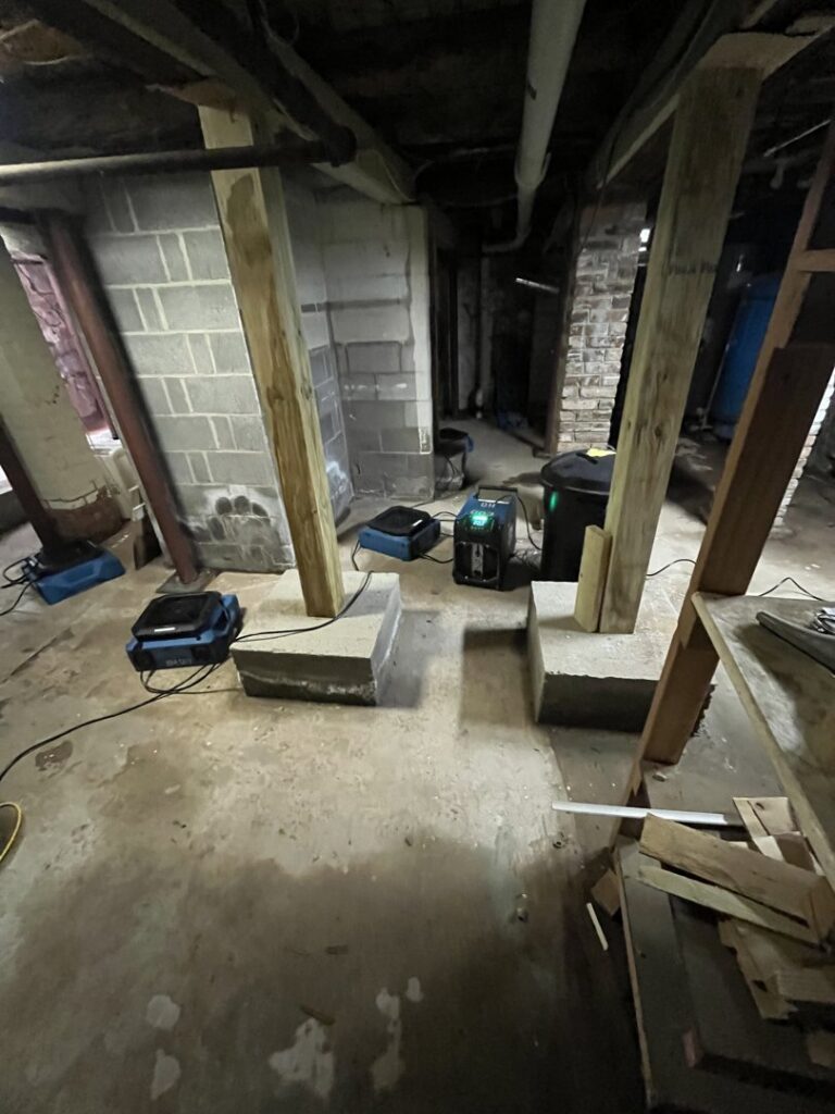 Industrial drying equipment in a basement after water damage restoration by RestoPros of New Haven in Prospect, CT