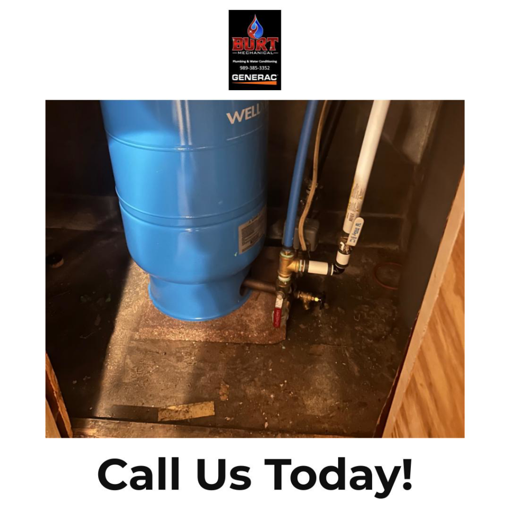 A basement floor showing signs of water damage and a well tank, serviced by Burt Mechanical in Flint, MI.
