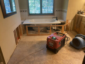 A basement undergoing water damage remediation with exposed studs and insulation by Minneapolis Water Damage Specialist 24/7 in Minneapolis, MN.