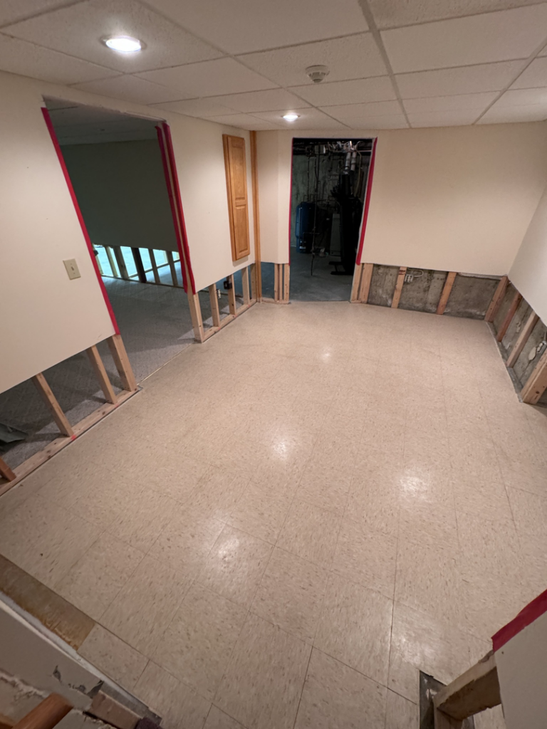 A basement undergoing water damage remediation with drywall removed from lower walls by PROTECH Restoration & Cleaning in Philadelphia, PA.