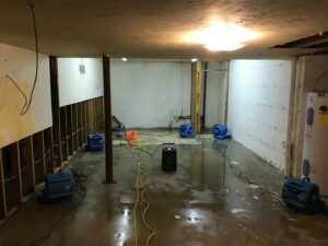 Basement with water damage, walls removed, and drying equipment in use by Complete Restoration and Construction, LLC in Yakima, WA