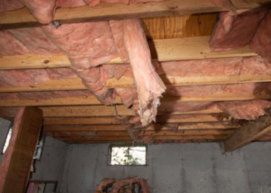 Basement ceiling showing water damage with sagging and damaged insulation, addressed by Fort Wayne Foundation Repair Experts in Fort Wayne, IN.