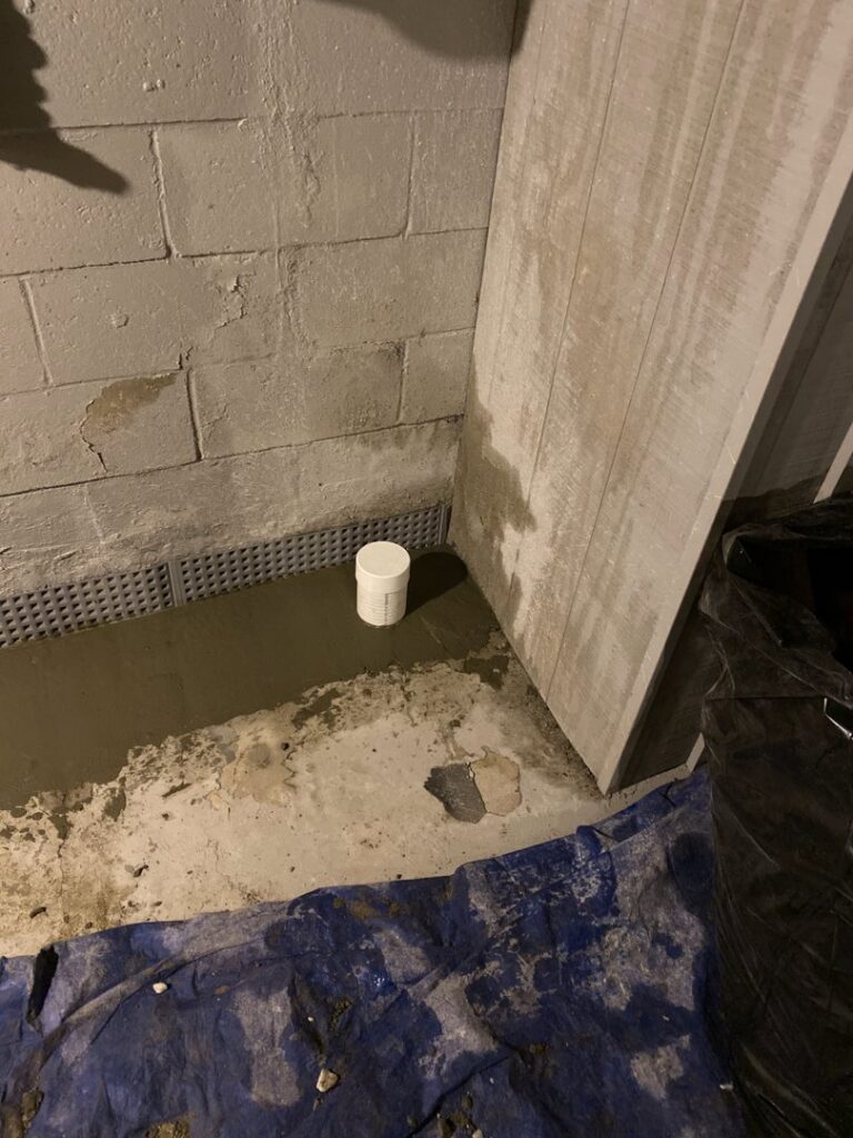 Basement waterproofing with a dimpled membrane and fresh concrete by EFFECTIVE WATERPROOFING in Worcester, MA.